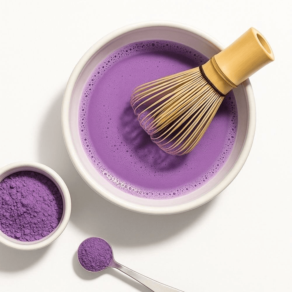 Raw vibrant purple Ube yams next to a scoop of finely milled violet Ube powder